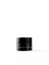 OSHAN ACACIA Balm in its small black glass jar on a white background.