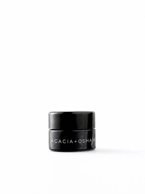 OSHAN ACACIA Balm in its small black glass jar on a white background.