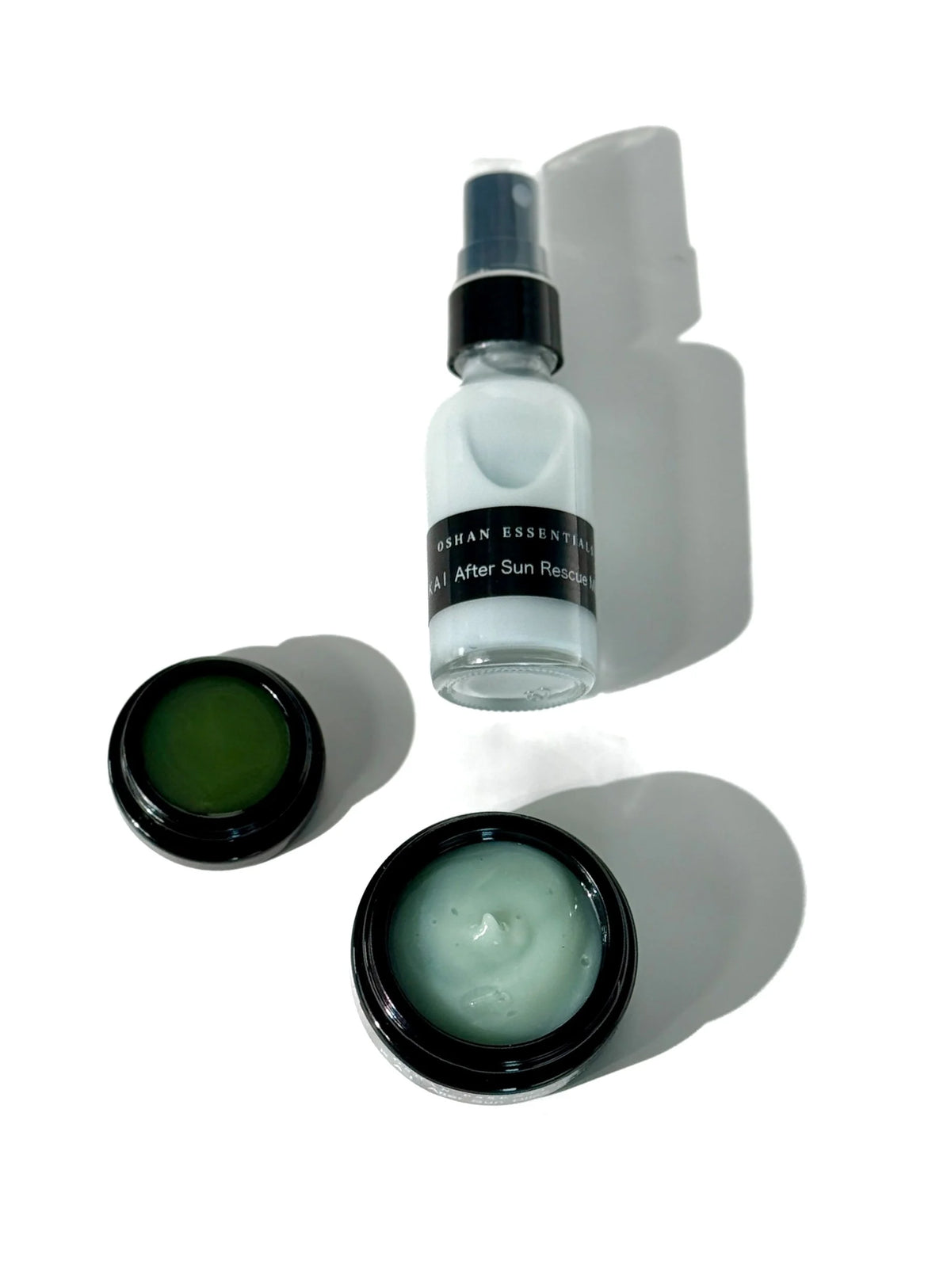 OSHAN After Sun Rescue Set bottle and open jars arranged on a pale surface.