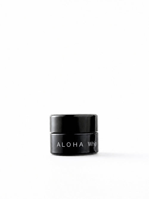 OSHAN ALOHA Lip Vitality Balm in its small black jar on a white background.