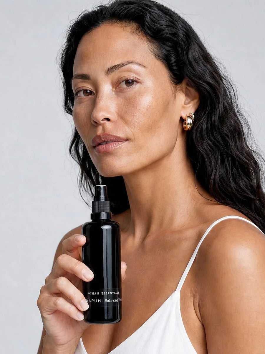 Model holding the OSHAN ʻAWAPUHI Balancing Toner bottle at her chest.