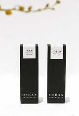 The two OSHAN BASIC Set boxes standing under a branch of small yellow blossoms.