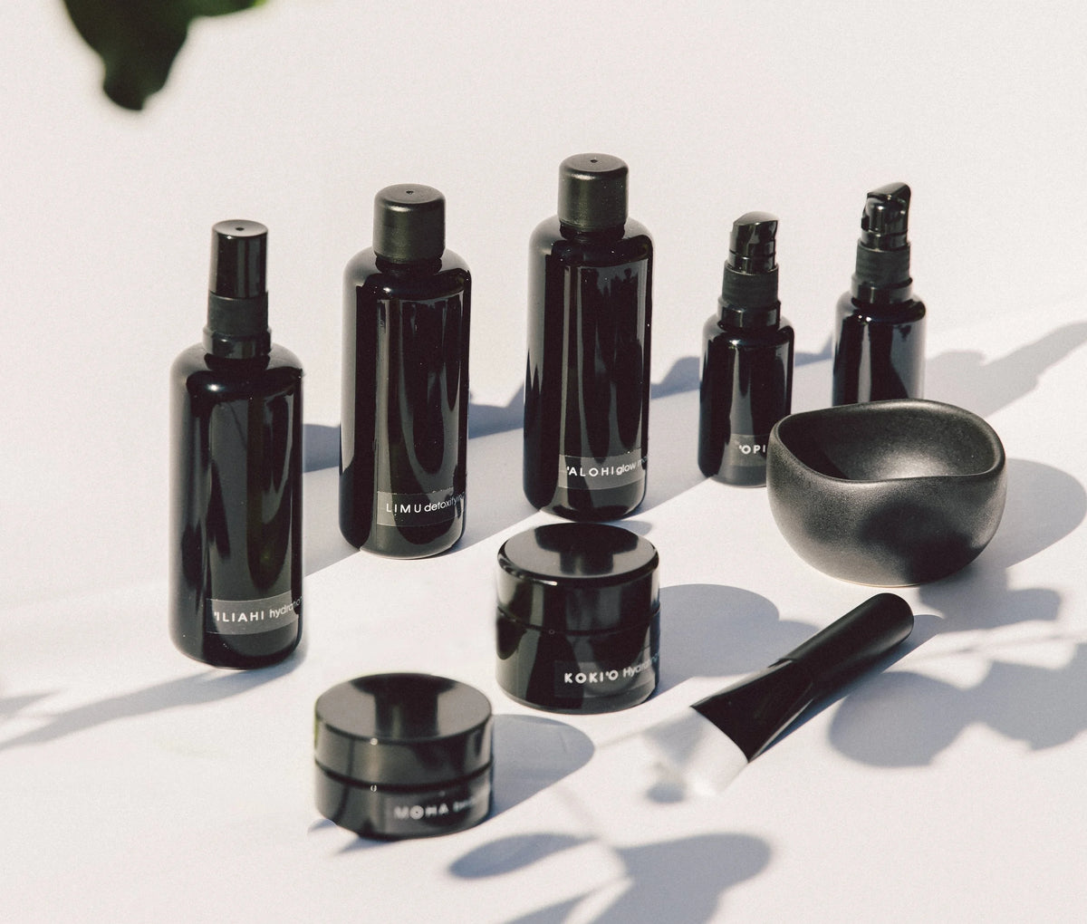 OSHAN Full Facial Ritual Set bottles and jars arranged with the black mixing bowl and spatula.