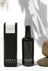 OSHAN ʻĪLIAHI Hydration Mist bottle and box beside smooth river stones.