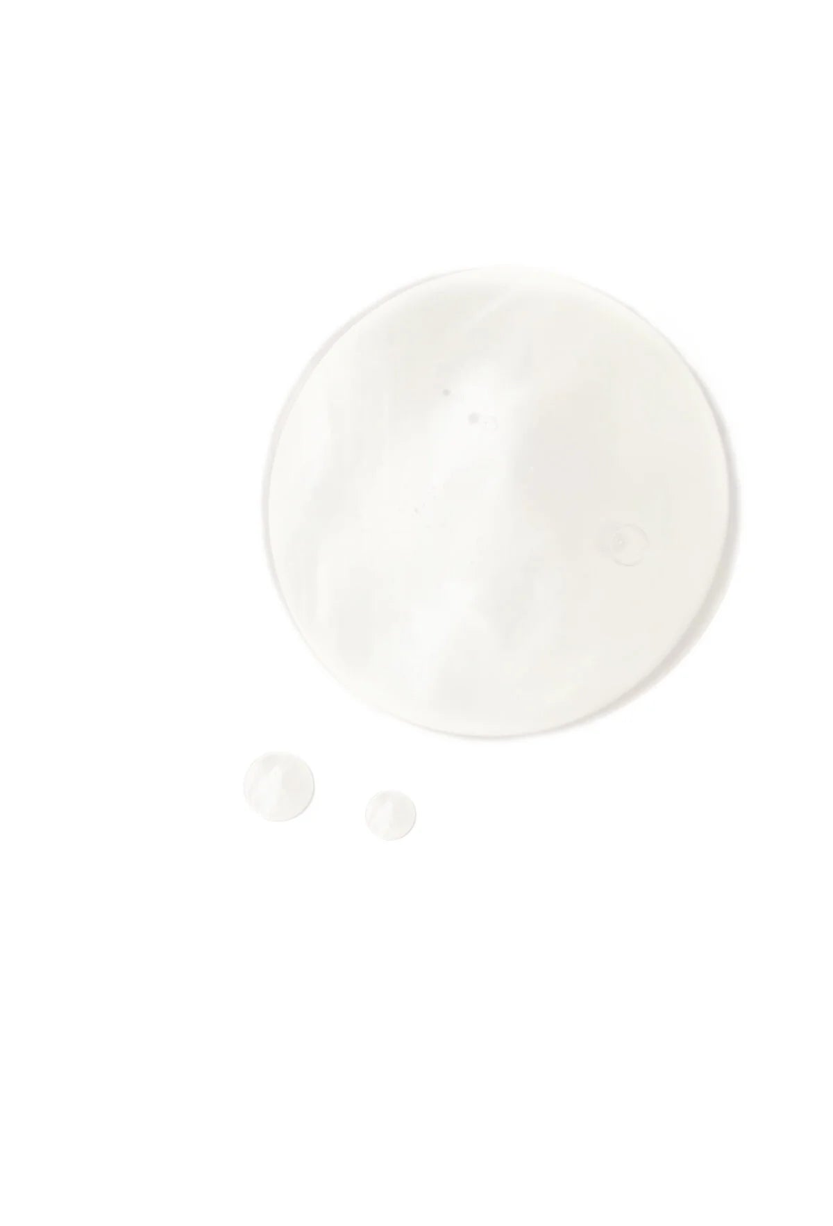 A clear droplet of OSHAN ʻĪLIAHI Hydration Mist on a white surface.