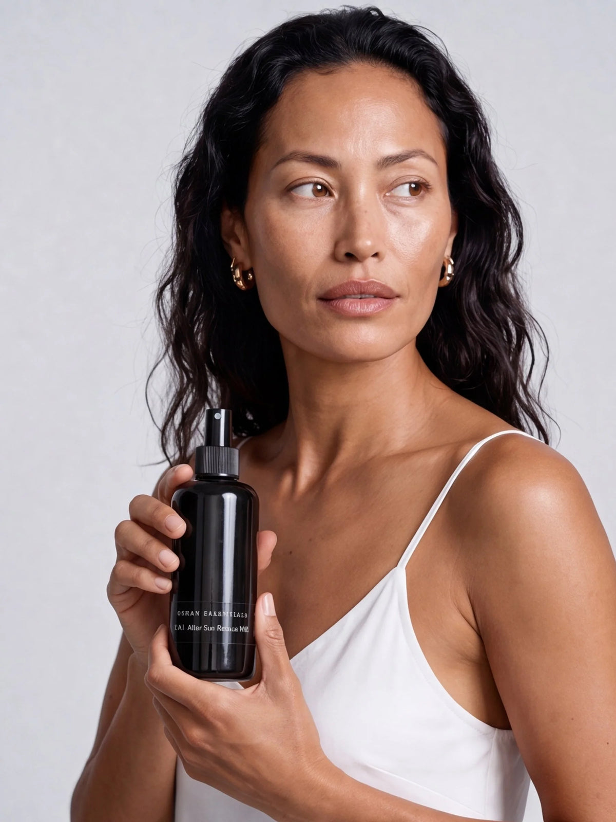 Model holding a bottle of OSHAN KAI After Sun Rescue Milk.