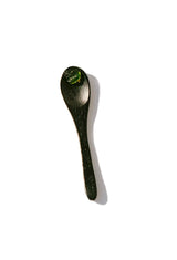 OSHAN LĪHAU Restoring Gelée on a black spoon against white.
