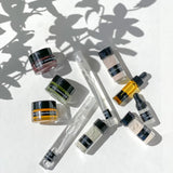 OSHAN Mini Facial Ritual Set trial sizes scattered under leaf shadow.