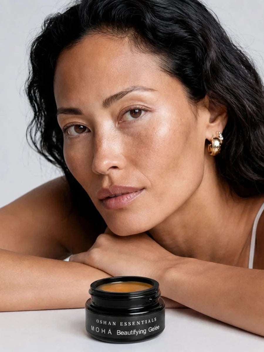 Model resting her chin on her arms beside a jar of OSHAN MOHĀ Beautifying Concrete Gelée.