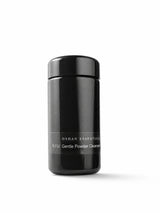 OSHAN NIU Cleansing Powder in its black bottle on a white background.