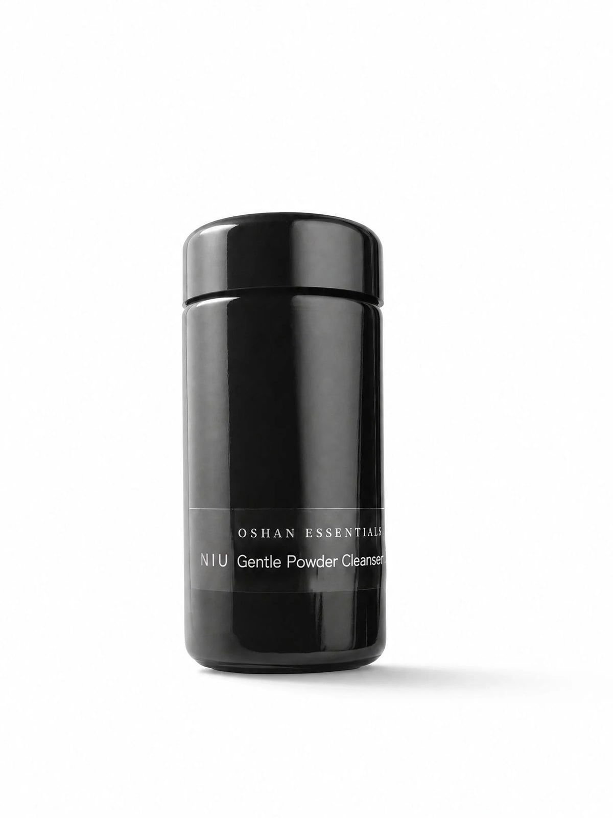 OSHAN NIU Cleansing Powder in its black bottle on a white background.