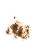 Loose OSHAN NIU Cleansing Powder poured in a small heap on white.