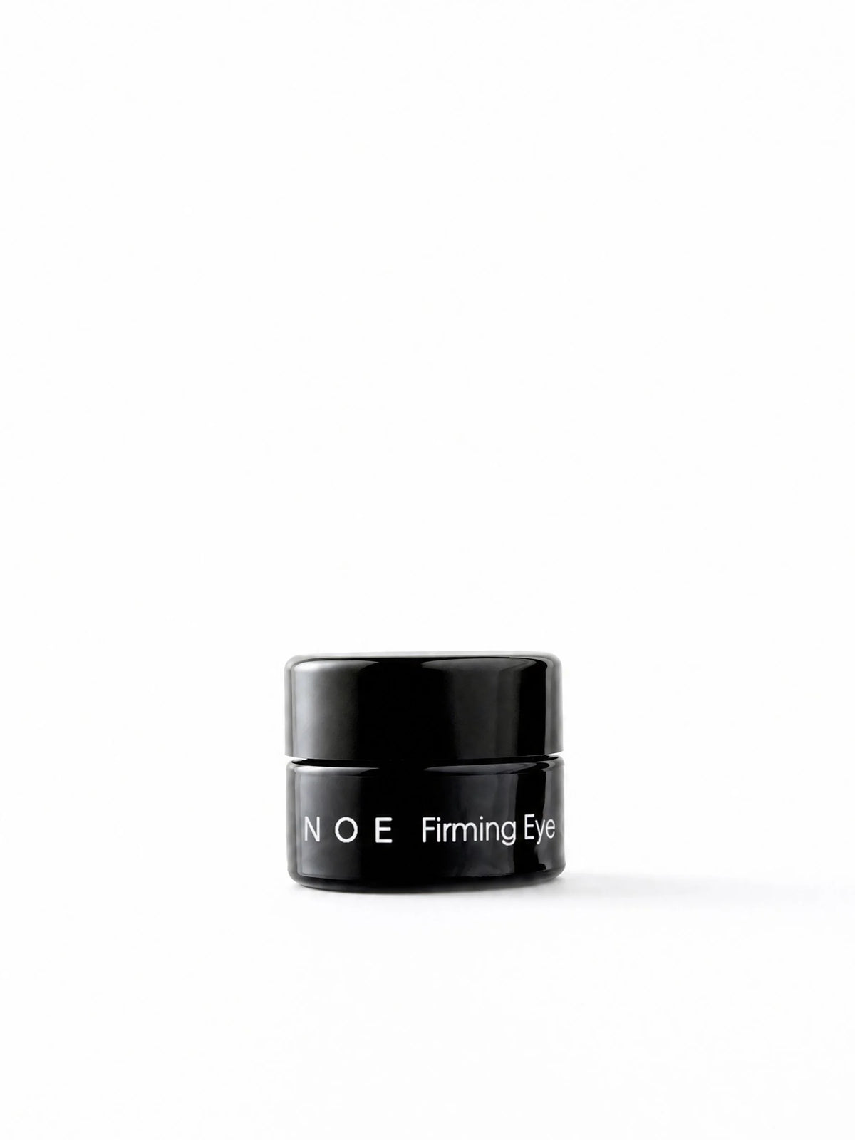 OSHAN NOE Firming Eye Cream in its small black jar on a white background.