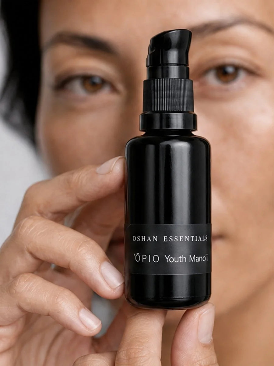 Model holding the OSHAN ʻŌPIO Youth Manoʻi bottle beside her face.