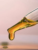 Golden OSHAN ʻŌPIO Youth Manoʻi oil dripping from a glass dropper.
