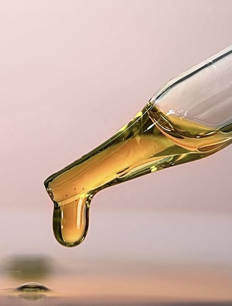 Golden OSHAN ʻŌPIO Youth Manoʻi oil dripping from a glass dropper.