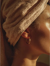 Model with her hair wrapped in a towel after the OSHAN SPA Set ritual.