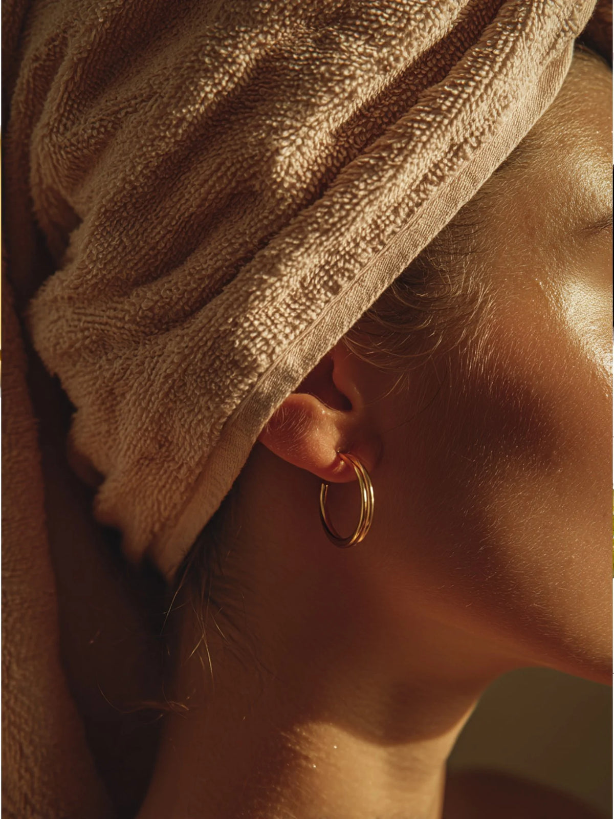 Model with her hair wrapped in a towel after the OSHAN SPA Set ritual.
